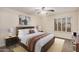 This bedroom is decorated with a bed, side tables, paintings, and window shutters at 917 N Blackbird Dr, Gilbert, AZ 85234
