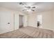 This empty room features neutral carpet, ceiling fan, multiple doors, and window shutters at 917 N Blackbird Dr, Gilbert, AZ 85234