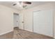 A standard bedroom with neutral walls, carpet, ceiling fan, closet and access to another room at 917 N Blackbird Dr, Gilbert, AZ 85234