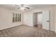 This bedroom is spacious with neutral carpet, ceiling fan, and multiple doors at 917 N Blackbird Dr, Gilbert, AZ 85234