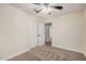 A standard bedroom with neutral walls, carpet, ceiling fan, closet and access to another room at 917 N Blackbird Dr, Gilbert, AZ 85234