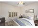 Bedroom features a stylish bed, arched window, and soft carpet at 917 N Blackbird Dr, Gilbert, AZ 85234