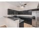Kitchen with sleek black cabinetry, granite countertops, and stainless steel appliances at 917 N Blackbird Dr, Gilbert, AZ 85234