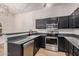 This kitchen offers stainless steel appliances, black cabinets and granite countertops at 917 N Blackbird Dr, Gilbert, AZ 85234