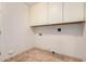 Functional laundry room features ample storage and easy-to-clean floors at 917 N Blackbird Dr, Gilbert, AZ 85234