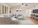 Bright living room with plush sectional sofa, stylish rug, and a ceiling fan at 917 N Blackbird Dr, Gilbert, AZ 85234