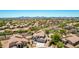 Beautiful aerial view of a home with lush desert landscaping and mountain views in the distance at 9203 E Topeka Dr, Scottsdale, AZ 85255