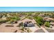 Beautiful aerial view of a house with lush desert landscaping, and mountain views in the distance at 9203 E Topeka Dr, Scottsdale, AZ 85255