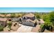 Stunning aerial view of a two-story home in a desert community, featuring a backyard pool at 9203 E Topeka Dr, Scottsdale, AZ 85255