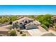 Beautiful home in a desert community, with a tile roof, three-car garage, and manicured landscaping at 9203 E Topeka Dr, Scottsdale, AZ 85255