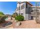 Spacious backyard showcasing the home's exterior, pool area, desert landscaping, and convenient storage unit at 9203 E Topeka Dr, Scottsdale, AZ 85255