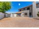 Home's backyard features a gravel area and an expansive house view with a stylish gray exterior at 9203 E Topeka Dr, Scottsdale, AZ 85255