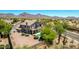 Aerial view of the backyard featuring a covered patio and private pool with views of mountains in the distance at 9203 E Topeka Dr, Scottsdale, AZ 85255