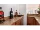 Wet bar featuring wood cabinetry and granite countertop at 9203 E Topeka Dr, Scottsdale, AZ 85255