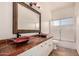 Bathroom showcasing double sinks with bowl-shaped basins and an ornate mirror above the marble countertop at 9203 E Topeka Dr, Scottsdale, AZ 85255