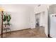 Neutral bedroom with tiled flooring, plant, and entry hallway at 9203 E Topeka Dr, Scottsdale, AZ 85255
