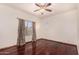 Bright bedroom featuring hardwood floors, neutral paint, and a window with beautiful curtains at 9203 E Topeka Dr, Scottsdale, AZ 85255