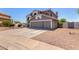 Spacious home featuring a three-car garage, ample driveway space, and xeriscaping offering a low-maintenance landscape at 9203 E Topeka Dr, Scottsdale, AZ 85255