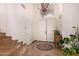 Bright foyer featuring a decorative chandelier and staircase at 9203 E Topeka Dr, Scottsdale, AZ 85255