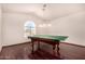 Bright game room featuring a ping pong table, hardwood floors, and a large window at 9203 E Topeka Dr, Scottsdale, AZ 85255