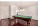 Game room featuring hardwood floors, neutral paint, and a hanging light fixture above the ping pong table at 9203 E Topeka Dr, Scottsdale, AZ 85255