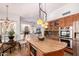 Bright open-concept kitchen featuring an island, granite countertops, stainless steel appliances, and seamless connection to the living spaces at 9203 E Topeka Dr, Scottsdale, AZ 85255