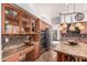 Spacious kitchen boasts stainless steel appliances, custom cabinets, center island and mosaic tile backsplash at 9203 E Topeka Dr, Scottsdale, AZ 85255