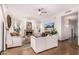 Bright living room with fireplace, white sofas, stylish decor and tiled flooring at 9203 E Topeka Dr, Scottsdale, AZ 85255