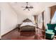 Spacious main bedroom with hardwood floors, ceiling fan, and a sitting area near the window at 9203 E Topeka Dr, Scottsdale, AZ 85255