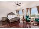 Spacious main bedroom with hardwood floors, vaulted ceilings, ceiling fan, and large windows providing natural light and views at 9203 E Topeka Dr, Scottsdale, AZ 85255