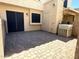 Backyard patio features brick pavers and the building's stucco exterior wall at 921 W University Dr # 1038, Mesa, AZ 85201
