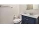 Bathroom with standard height toilet, modern silver hardware, and navy blue vanity at 921 W University Dr # 1038, Mesa, AZ 85201