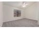 Bedroom with light gray carpeting, vaulted ceiling, and ceiling fan at 921 W University Dr # 1038, Mesa, AZ 85201