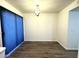 An empty dining room with wood floors and a modern light fixture, awaiting your personal touch at 921 W University Dr # 1038, Mesa, AZ 85201