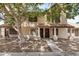 Two-story townhouse featuring a tile roof, covered entrance, and mature landscaping at 921 W University Dr # 1038, Mesa, AZ 85201