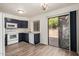 Functional kitchen with white appliances, dark cabinets, and a sliding glass door to patio at 921 W University Dr # 1038, Mesa, AZ 85201
