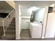 Convenient laundry area with modern appliances, storage, and easy access to the staircase at 921 W University Dr # 1038, Mesa, AZ 85201