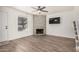 Inviting living room showcasing a stone fireplace, wood floors, and a contemporary ceiling fan at 921 W University Dr # 1038, Mesa, AZ 85201