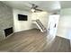 Bright living room featuring modern flooring, stone fireplace, staircase, and modern fixtures at 921 W University Dr # 1038, Mesa, AZ 85201