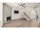Spacious living room with a fireplace, wood floors, and a staircase leading to the upper level at 921 W University Dr # 1038, Mesa, AZ 85201