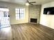 Open living room with modern floors, a stone fireplace, and ample natural light at 921 W University Dr # 1038, Mesa, AZ 85201