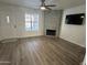 Beautiful living room with stylish floors, a cozy fireplace, and large window at 921 W University Dr # 1038, Mesa, AZ 85201