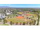 A beautiful view of a well kept community baseball field with walkways, landscaping, and community center at 9750 E Radioactive Dr, Mesa, AZ 85212