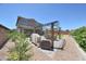 Spacious backyard with an outdoor dining area, grill, and ample space for entertaining at 9750 E Radioactive Dr, Mesa, AZ 85212