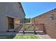View of the backyard featuring a wooden fence and a small grassy area at 9750 E Radioactive Dr, Mesa, AZ 85212