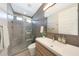 Stylish bathroom showcasing a glass-enclosed shower, sleek vanity, and modern fixtures with minimalist design at 9750 E Radioactive Dr, Mesa, AZ 85212