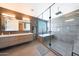 Modern bathroom featuring a glass shower, soaking tub, and double sink vanity with neutral tones at 9750 E Radioactive Dr, Mesa, AZ 85212