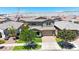 Charming two-story home featuring manicured front lawn, mature shade trees, and a two car garage at 9750 E Radioactive Dr, Mesa, AZ 85212