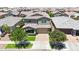 Beautiful two-story home with a manicured lawn, mature trees, and a charming front porch at 9750 E Radioactive Dr, Mesa, AZ 85212