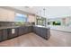 This spacious kitchen features an island with granite countertops, modern appliances, and opens to the living room at 9750 E Radioactive Dr, Mesa, AZ 85212